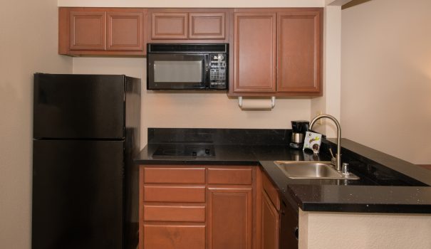 Microwave, refrigerator and stovetop in a Larkspur Landing studio suite
